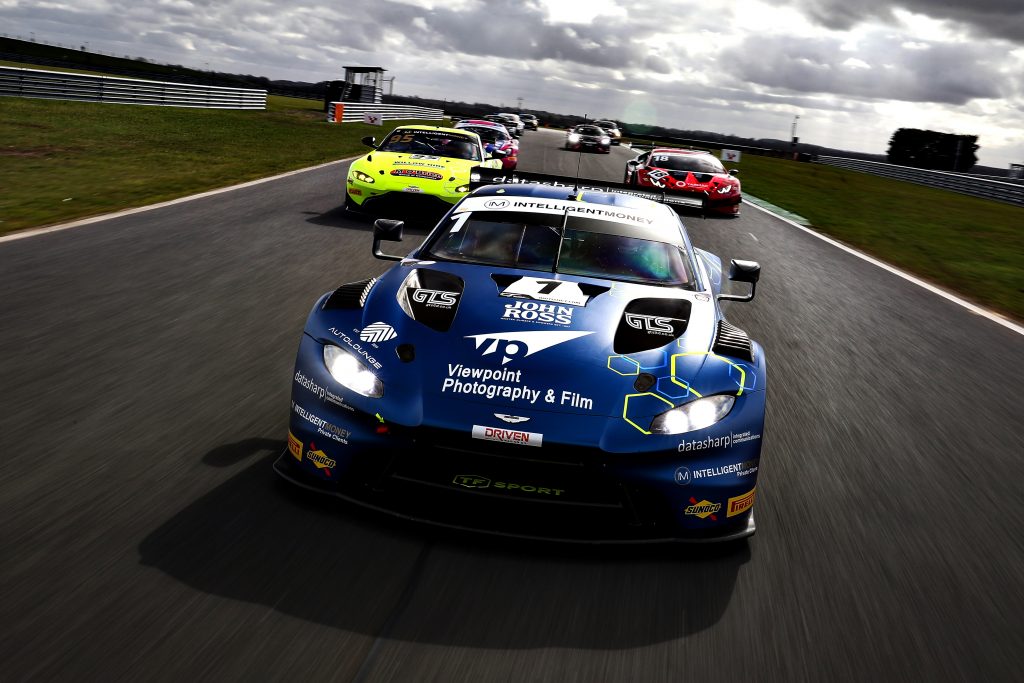 An Aston Martin GT3 car leads a pack of British GT cars in a tracking shot.